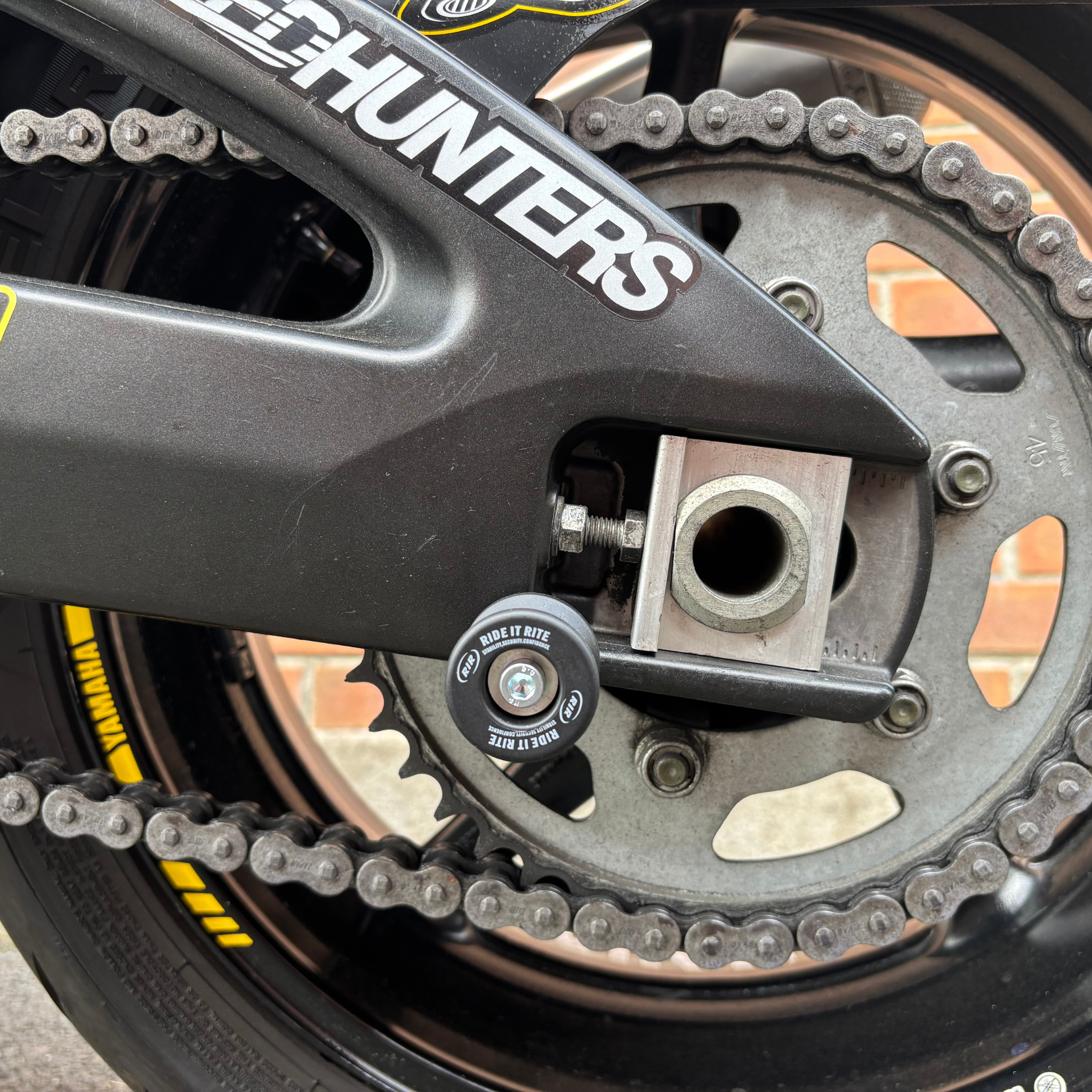 Close up of a Ride t Rite swing-arm spool on a motorbike