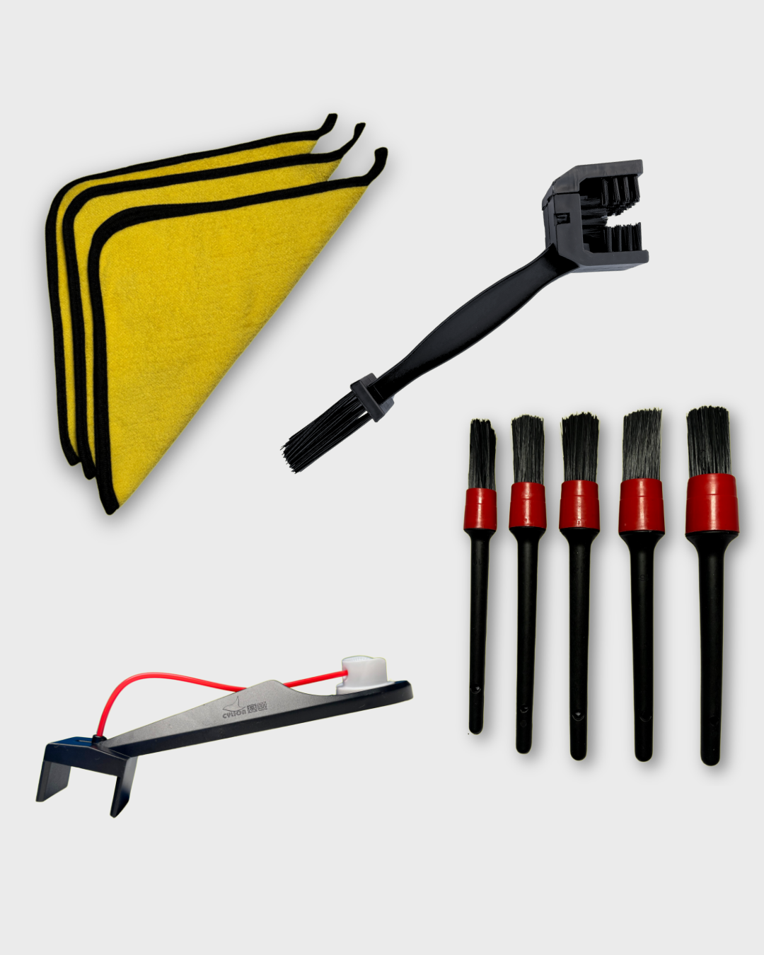 A Detailing bundle with a set of 3 yellow microfiber cleaning cloths A black Ride It Rite motorcycle chain cleaning brush a set of 5 black and red detailing brush set and a black chain oil sprayer on a light grey background
