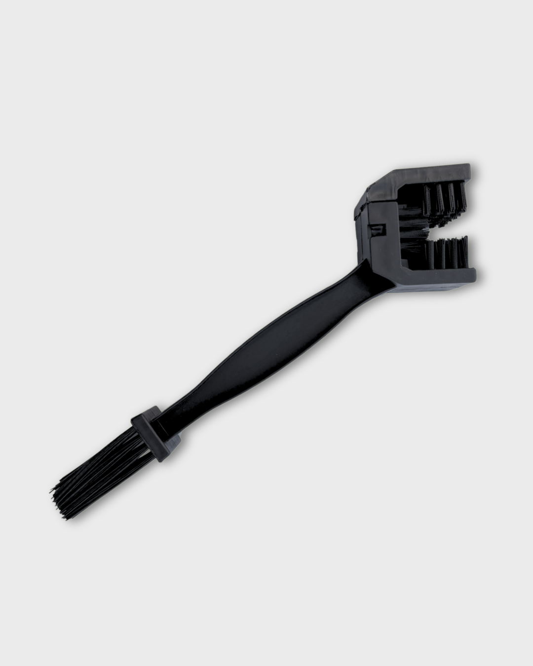 A black Ride It Rite plastic dual-bristle chain cleaning brush with a long handle and a wide, angled head, shown on a light gray background.