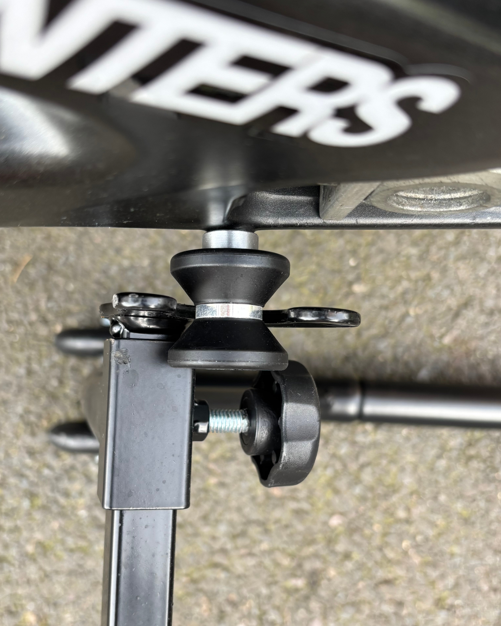 Close up of A Ride It Rite swing-arm spool attached to a motorbike  being lifted on a Ride  paddock stand.